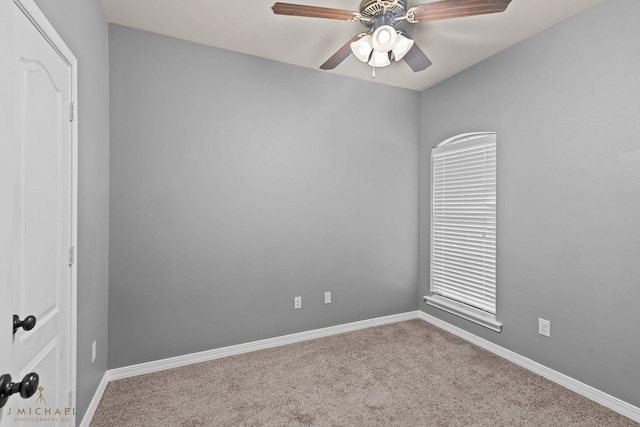 carpeted spare room featuring ceiling fan