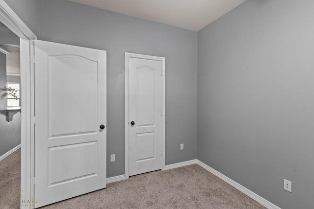 unfurnished bedroom featuring light colored carpet