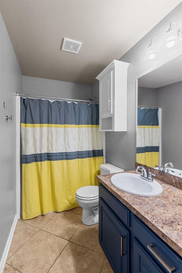 bathroom with vanity, tile patterned floors, toilet, and walk in shower