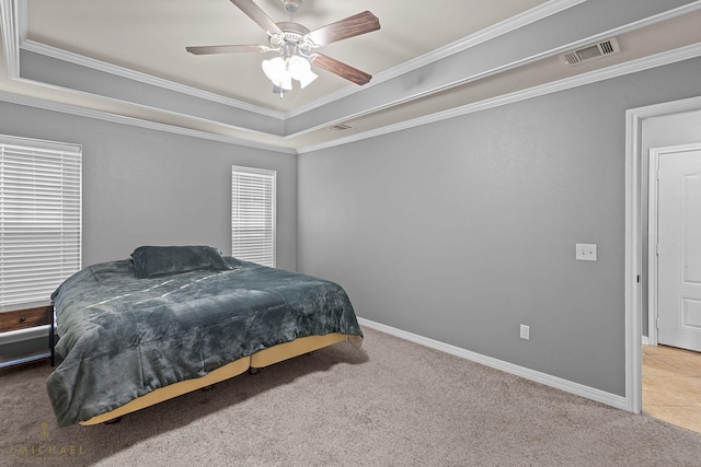 carpeted bedroom featuring ceiling fan, ornamental molding, and a raised ceiling