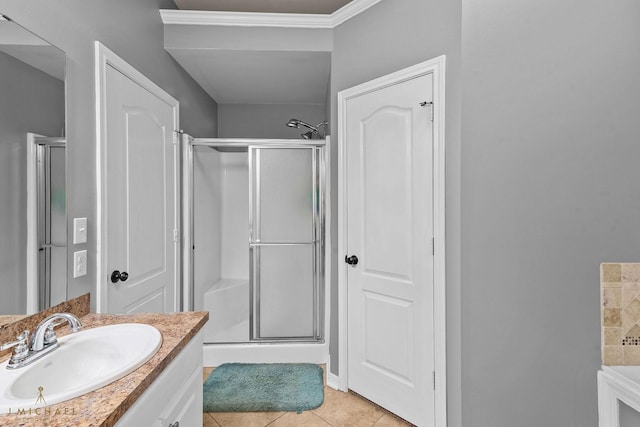 bathroom featuring tile patterned flooring, vanity, and a shower with shower door