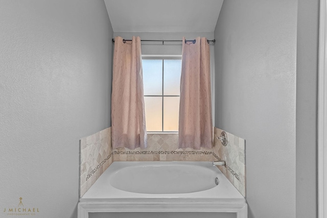 bathroom with a wealth of natural light and a tub to relax in