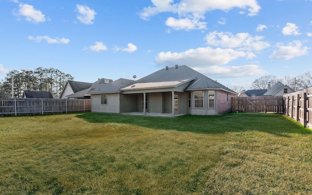 rear view of house featuring a patio and a yard