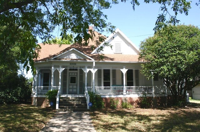 view of front of home with a front lawn and a porch