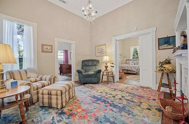 living room featuring hardwood / wood-style floors, plenty of natural light, and a notable chandelier