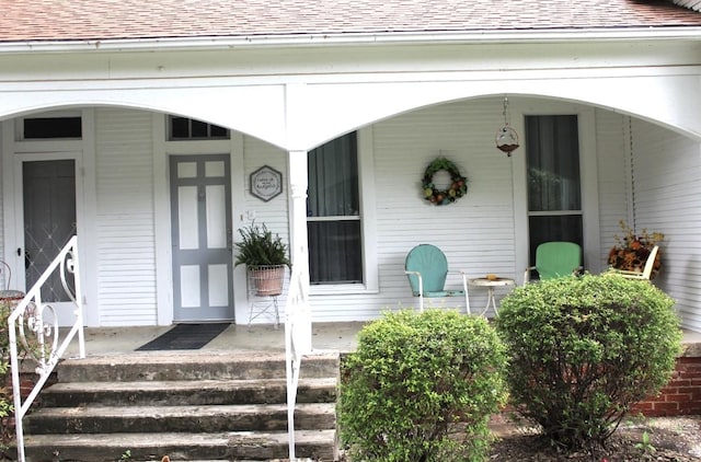 view of exterior entry with covered porch