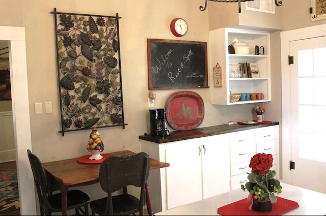 bar featuring white cabinetry