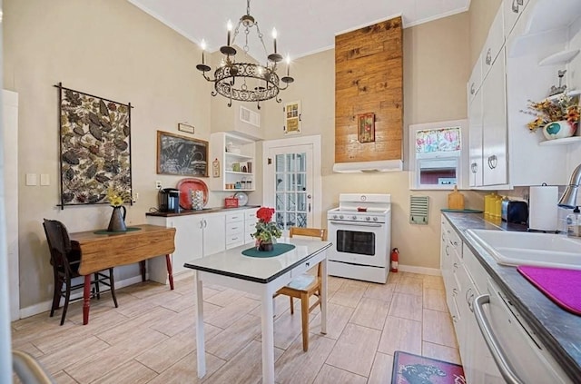 kitchen with sink, white electric range oven, white cabinetry, and pendant lighting