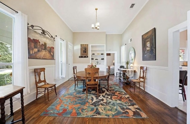 dining room featuring a notable chandelier, plenty of natural light, and dark hardwood / wood-style flooring