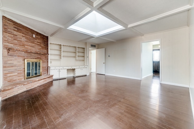 unfurnished living room featuring a fireplace, beamed ceiling, and coffered ceiling