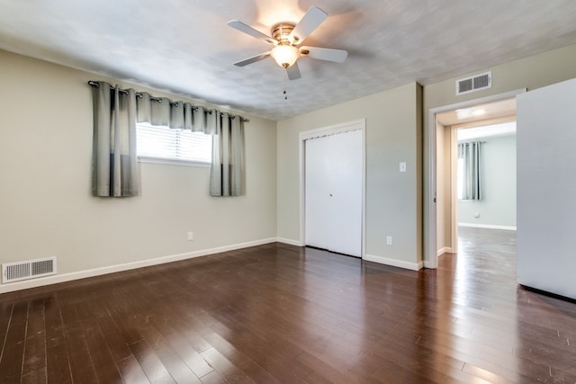 spare room featuring ceiling fan and dark hardwood / wood-style flooring