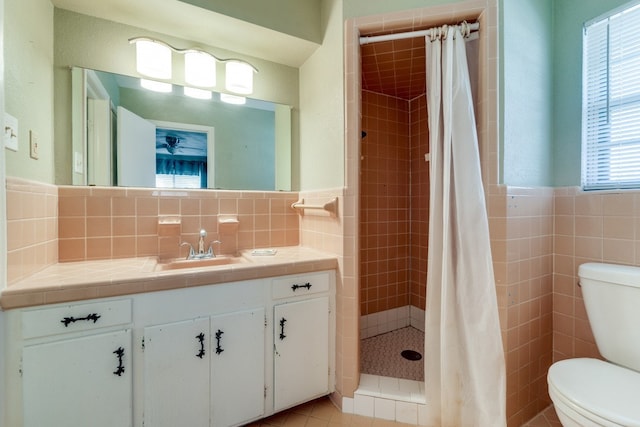 bathroom featuring tile patterned flooring, vanity, a shower with curtain, tile walls, and toilet