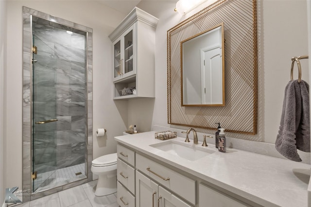 bathroom with toilet, a shower with shower door, and vanity