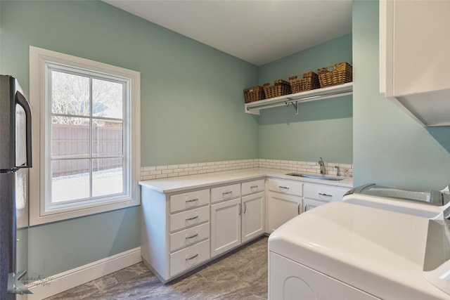 washroom featuring sink and washer / dryer