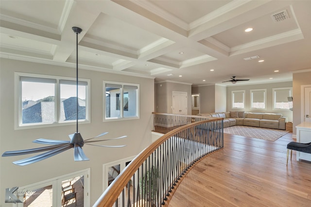 hallway featuring crown molding, coffered ceiling, light wood-type flooring, french doors, and beam ceiling