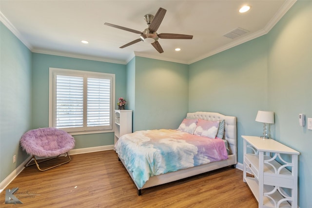 bedroom with hardwood / wood-style flooring, ceiling fan, and ornamental molding