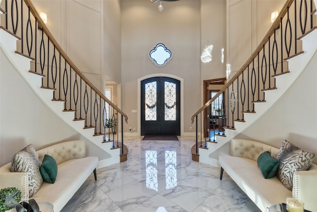 foyer featuring french doors and a high ceiling