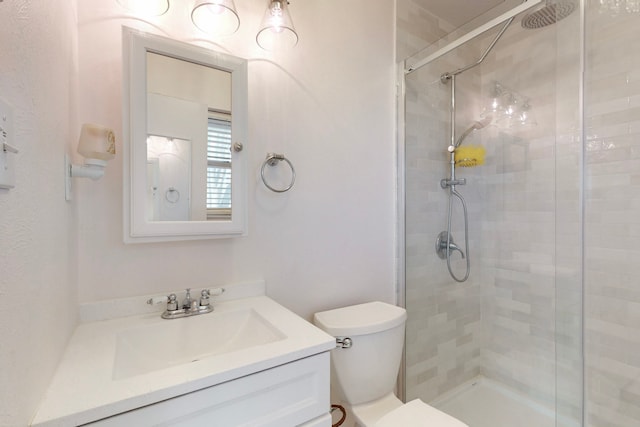 bathroom with an enclosed shower, vanity, and toilet