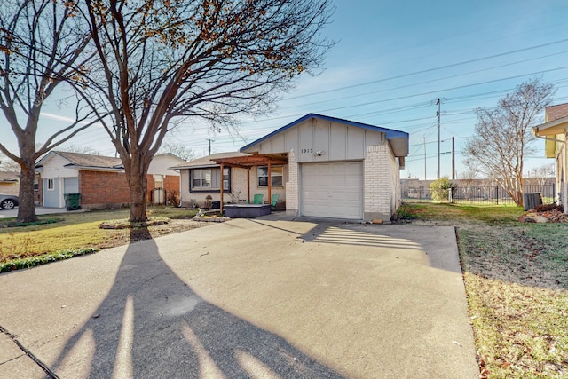 single story home with a garage and a front lawn