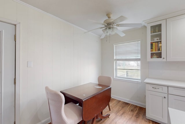 office space with ornamental molding, ceiling fan, and light wood-type flooring