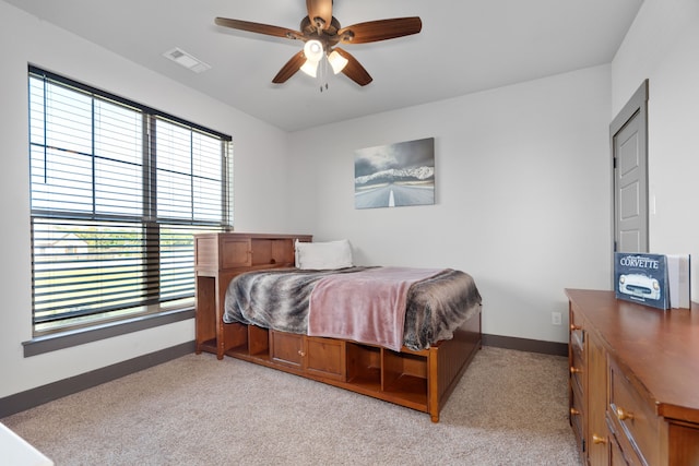 bedroom featuring baseboards, multiple windows, and visible vents