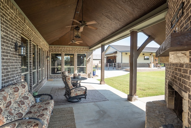 view of patio with a ceiling fan and an outdoor brick fireplace