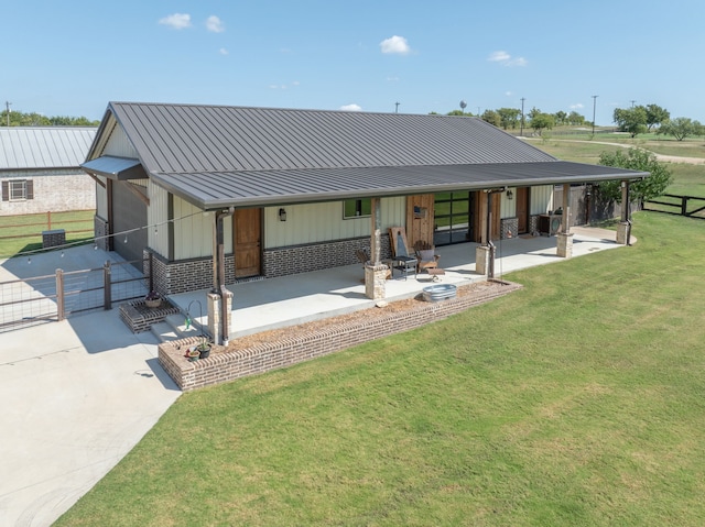 back of property with a patio and a yard