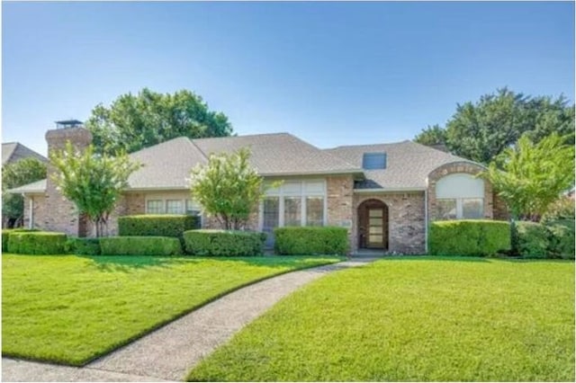 ranch-style house with a front lawn