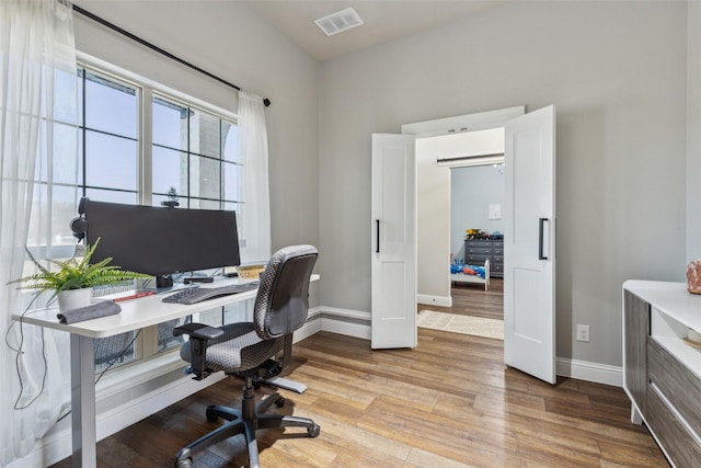 office area with light hardwood / wood-style floors