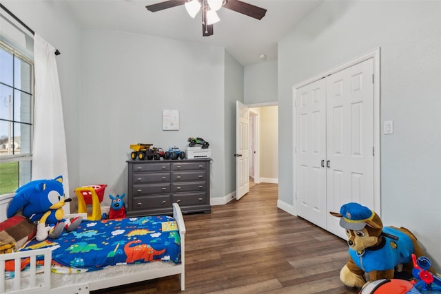 bedroom with dark hardwood / wood-style flooring, a closet, and ceiling fan