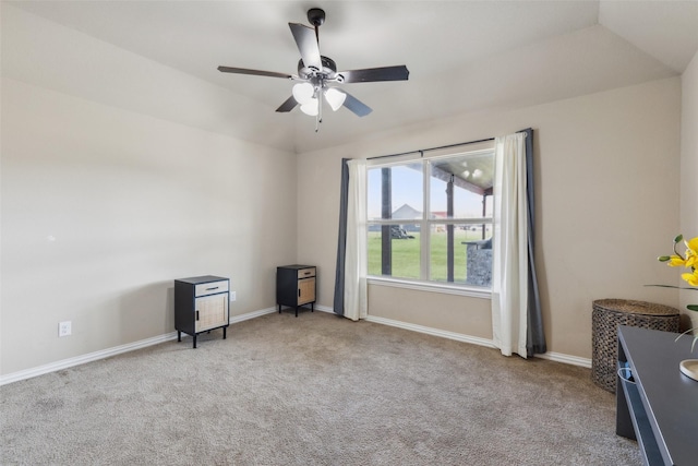 spare room featuring ceiling fan, light colored carpet, lofted ceiling, and a tray ceiling