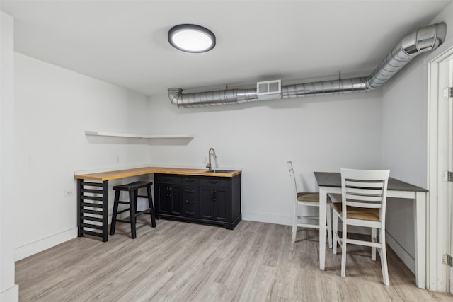 office area with sink and light wood-type flooring