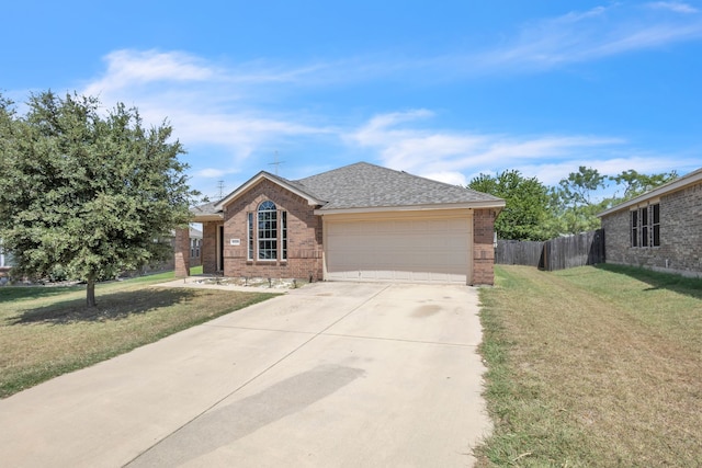 ranch-style house with a garage and a front lawn