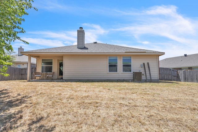 rear view of house with a yard and a patio