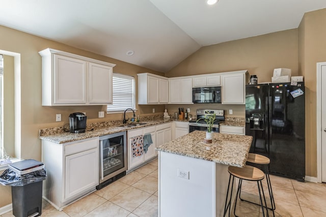 kitchen with sink, black appliances, white cabinetry, and wine cooler