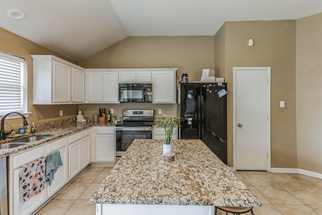 kitchen with black appliances, a center island, light stone counters, and sink