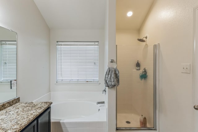 bathroom featuring vanity and shower with separate bathtub