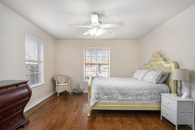 bedroom featuring multiple windows, dark hardwood / wood-style floors, and ceiling fan