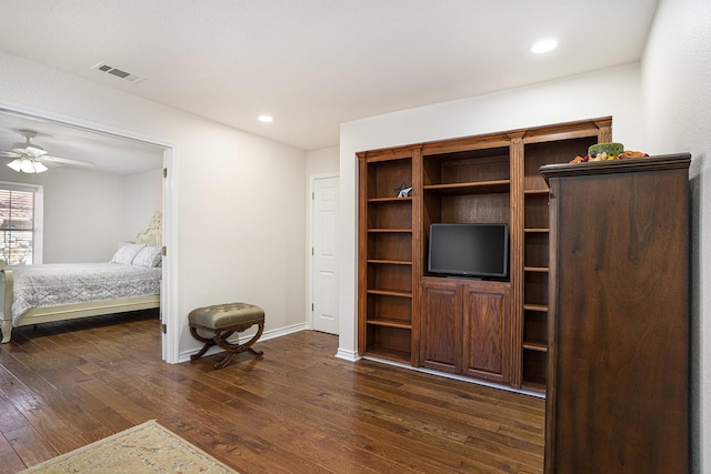 bedroom with dark hardwood / wood-style flooring