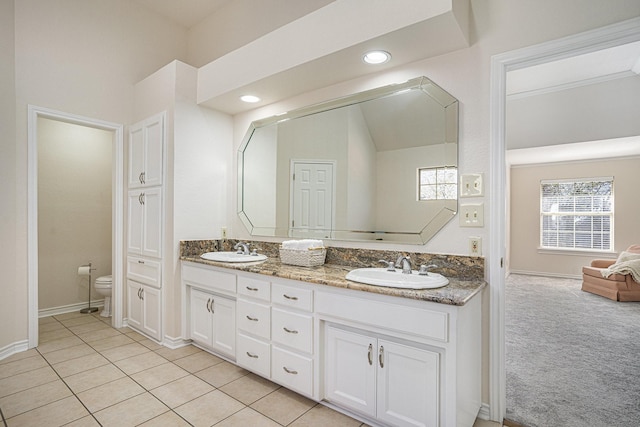 bathroom featuring vanity, tile patterned floors, toilet, and lofted ceiling