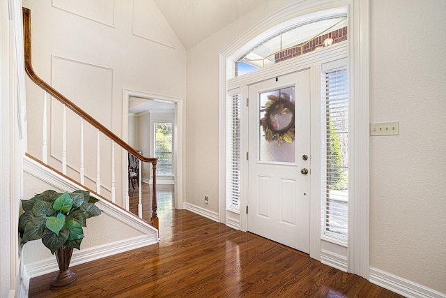 entrance foyer featuring dark hardwood / wood-style floors and vaulted ceiling