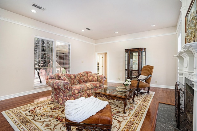 living room featuring ornamental molding and dark hardwood / wood-style floors