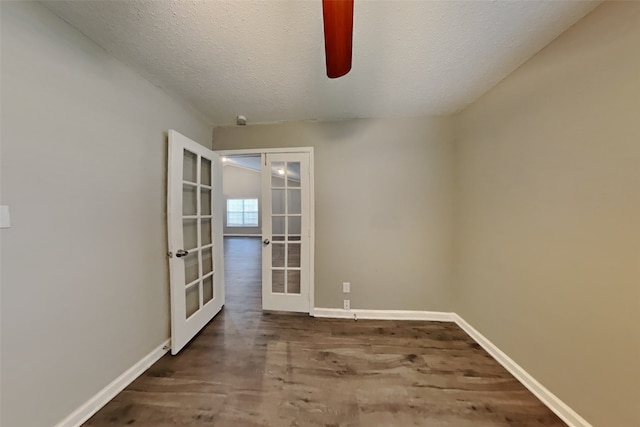 spare room featuring french doors, a textured ceiling, and wood-type flooring