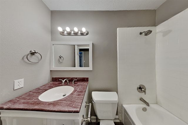 full bathroom featuring a textured ceiling, toilet, vanity, and tiled shower / bath