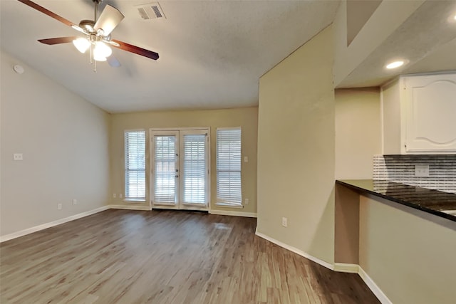 interior space with ceiling fan, french doors, and light wood-type flooring