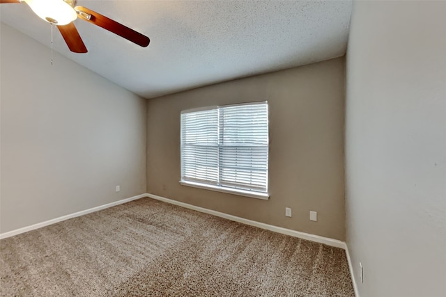 spare room with vaulted ceiling, carpet, ceiling fan, and a textured ceiling