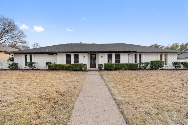 ranch-style home with a front lawn