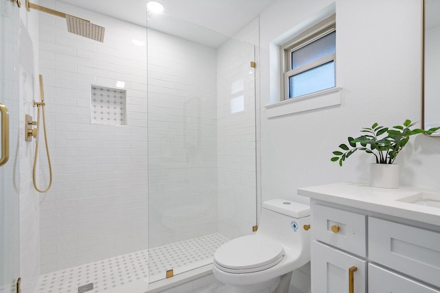 bathroom featuring vanity, toilet, and walk in shower