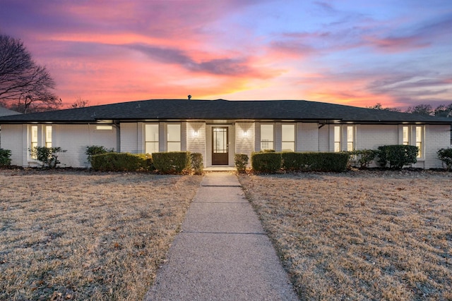 ranch-style home featuring a yard