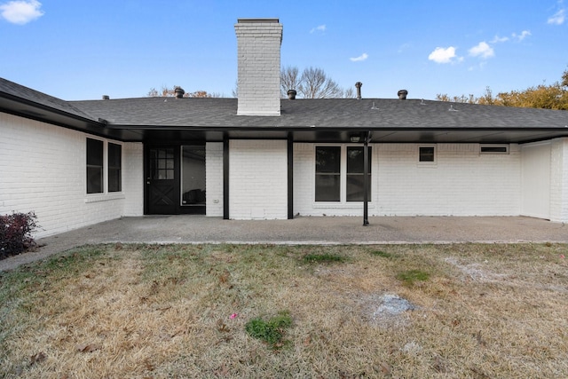 back of house featuring a lawn